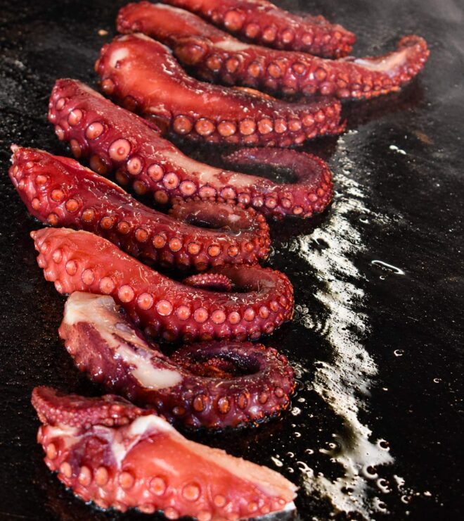 Octopus tentacle cooking on the brasero at La Vieille Fontaine in Maisons-Laffitte, wood-fire grilled